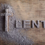 Lent word written in ash, dust as fast and abstinence period concept.